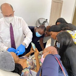 Aesthetic Professionals Observe A Cosmetic Treatment In A Modern Clinic, Emphasizing Training, Collaboration, And Patient Safety. Aesthetic Training Session With Professionals Observing Cosmetic Procedure In Modern Clinic.