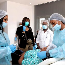 Medical Team Performs A Skincare Procedure On A Calm Patient In A Modern, Sterile Clinic. Skintisfaction Team Performing Aesthetic Training In Lagos.