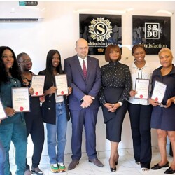 Group Of Professionals Celebrating Their Certification Achievement At A Vibrant Training Event. Happy Graduates Celebrating Their Certification Achievement At A Professional Development Event.